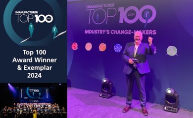 A rectangular image with The Manufacturer Top 100 2024 Awards logo at the top left with the words ‘Top 100 Award Winner & Exemplar 2024’ written in white underneath that and a wide shot of all 100 award recipients stand on the stage with their trophies and then a larger image to the right of Jean-Michel Sintome (a white male wearing a dark blue suit and brown shoes) smiling whilst standing in front of the stage backdrop, holding his trophy with one hand and punching the air with the other.