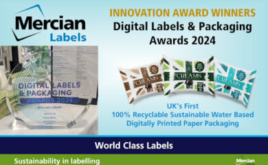 A rectangular image with a light blue background and the words ‘Digital Labels & Packaging Awards 2024 Innovation Award Winners’ across the top right, with images of three different union jack based packaging designs below that and the text ‘UK’s First 100% Recyclable Sustainable Water Based Digitally Printed Paper Packaging’ underneath them, whilst to the left hand side is a photo of Innovation Award Winners trophy on a table at the awards ceremony surrounded by napkins, wine glasses and an event programme.