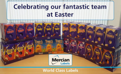 A display of various Cadbury and Terry’s chocolate Easter eggs arranged on a table, including Wispa, Twirl, Crunchie, Caramilk, Dairy Milk, Creme Egg, and Terry’s Chocolate Orange Mini Eggs. A sign above the display reads "Celebrating our fantastic team at Easter." At the bottom, the Mercian Labels logo appears with the tagline "World Class Labels."