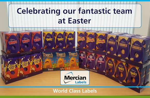 A display of various Cadbury and Terry’s chocolate Easter eggs arranged on a table, including Wispa, Twirl, Crunchie, Caramilk, Dairy Milk, Creme Egg, and Terry’s Chocolate Orange Mini Eggs. A sign above the display reads "Celebrating our fantastic team at Easter." At the bottom, the Mercian Labels logo appears with the tagline "World Class Labels."