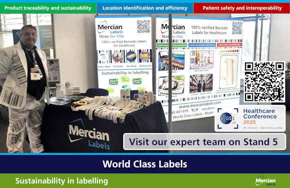 A man wearing a white suit covered in barcode designs stands next to a trade show booth for Mercian Labels at the GS1 Healthcare Conference 2025, held at the QEII Centre in London. The booth features rolls of barcode labels, promotional materials, and two large backlit banners highlighting the company's services: 100% verified barcode labels for healthcare, emphasising sustainability, efficiency, and patient safety. A sign invites attendees to visit the team at Stand 5. An event logo for the GS1 UK Healthcare Conference and QR code to the relevant page on the company website are also visible.