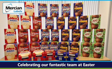 A display of various Nestle chocolate Easter eggs arranged on a table, including Milky Bar, KitKat, Smarties, Yorkie and peppermint Aero. Text across the base reads "Celebrating our fantastic team at Easter" and the Mercian Labels logo appears at the top left.